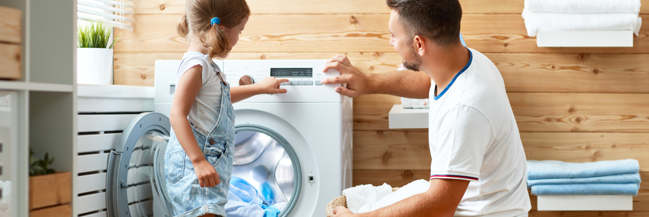 Father and daughter doing the washing together