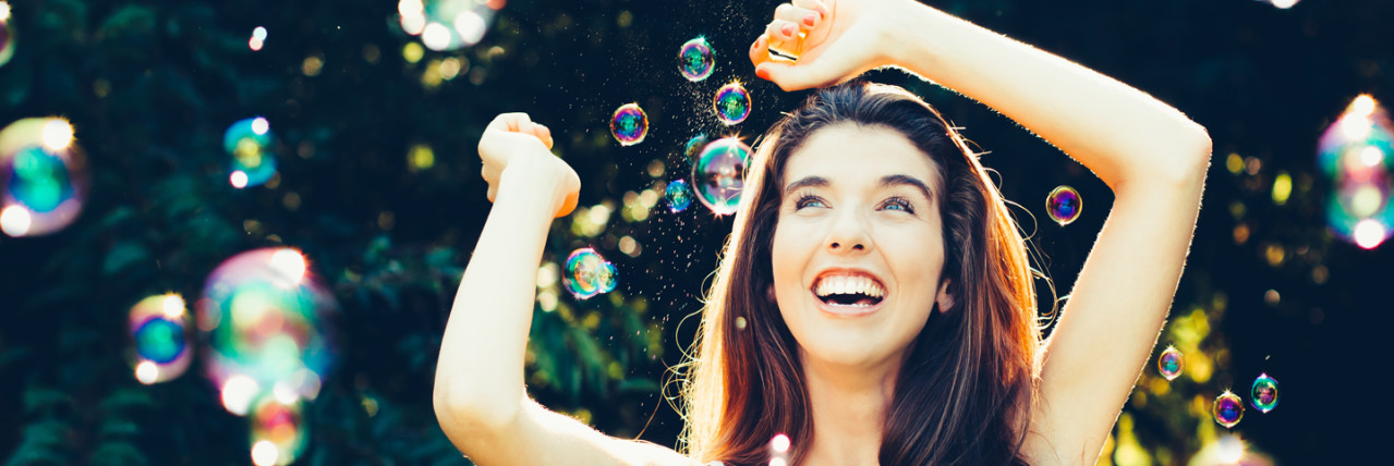 Girl dancing in bubbles