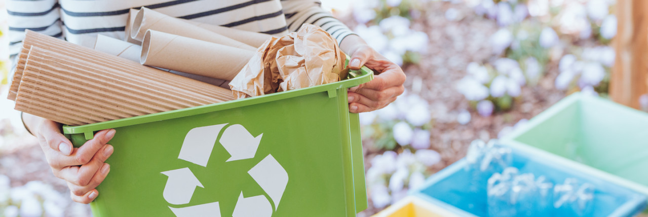 Person with a recycling box of cardboard